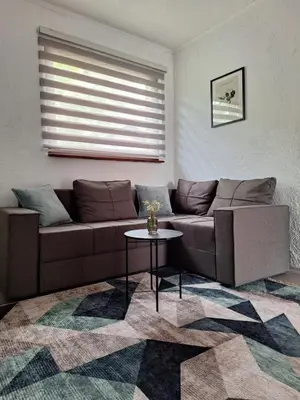 a living room with a couch and a table at Bloom in Šipovo