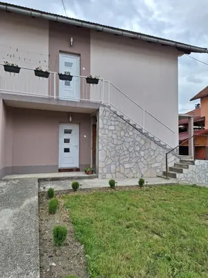 a house with a white door and a balcony at Bloom in Šipovo