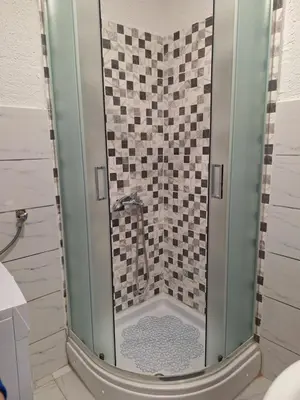 a shower with a glass door in a bathroom at Bloom in Šipovo