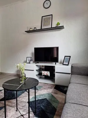 a living room with a tv and a coffee table at Bloom in Šipovo