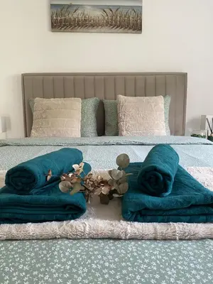 a bed with blue blankets and stuffed animals on it at Apartman Rawda 2 in Jajce