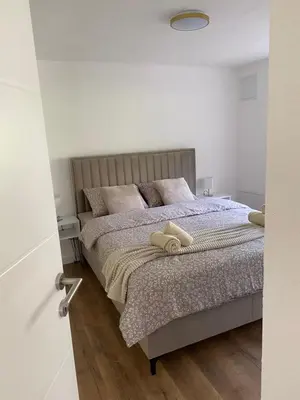 a bedroom with a bed with two towels on it at Apartman Rawda 2 in Jajce
