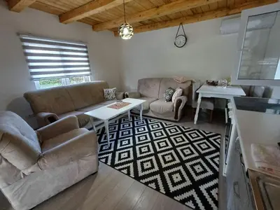 a living room with a couch and a table at Holiday Home AZER in Visoko
