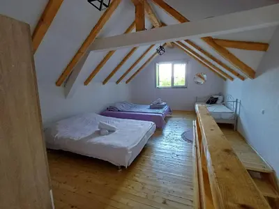 a room with two beds in a attic at Holiday Home AZER in Visoko