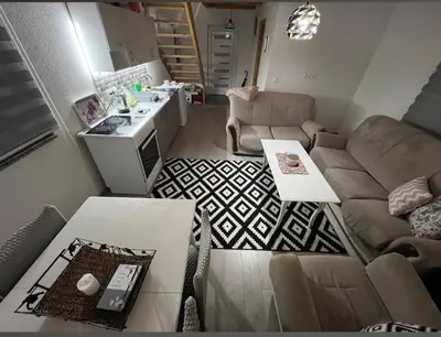 a living room with a couch and a table at Holiday Home AZER in Visoko