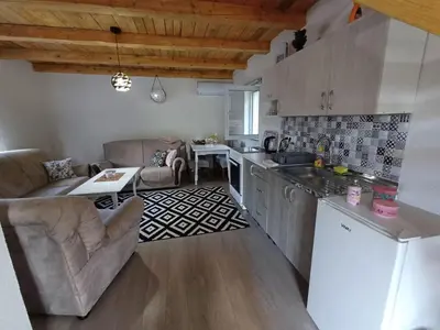 a kitchen and living room with a couch and a table at Holiday Home AZER in Visoko
