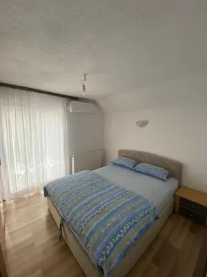 a bedroom with a bed with blue pillows on it at 