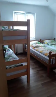 two bunk beds in a room with a window at 