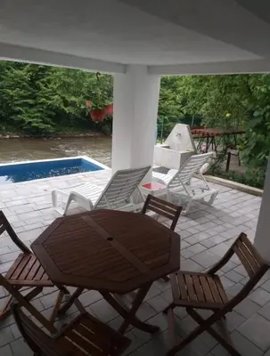 a patio with chairs and a table and a pool at 