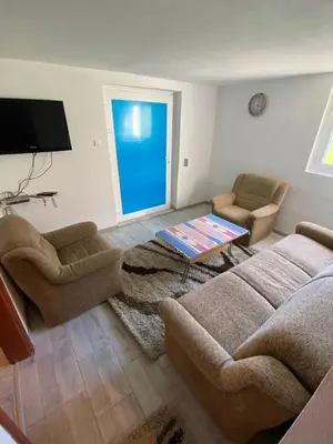 a living room with a couch and chairs and a tv at 