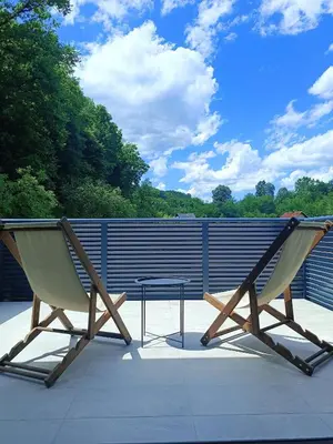 a pair of chairs and a table on a patio at Zen Loft in Tuzla