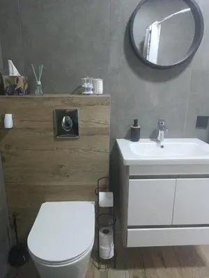 a bathroom with a white toilet and a mirror at Zen Loft in Tuzla