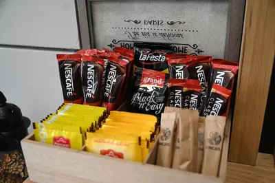 a box of chips and other snacks on a shelf at Elegance Apartmani Doboj Stan na dan in Doboj