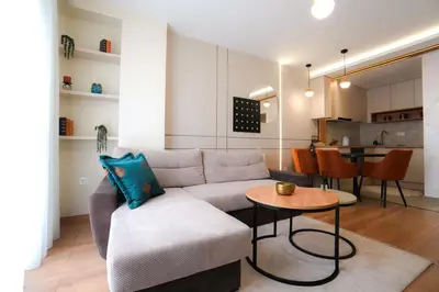 a living room with a couch and a table at Elegance Apartmani Doboj Stan na dan in Doboj
