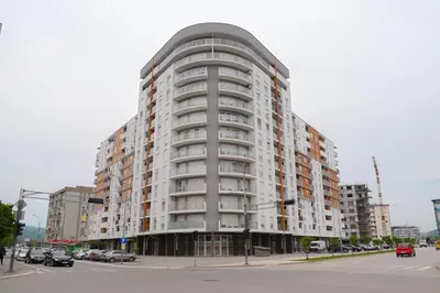 a large apartment building on the corner of a street at Elegance Apartmani Doboj Stan na dan in Doboj