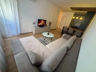 a living room with a couch and a table at Stan na dan Santo in Banja Luka