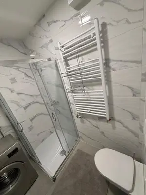 a bathroom with a shower and a toilet and a sink at Stan na dan Santo in Banja Luka