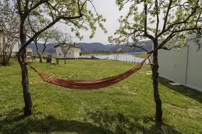 a hammock hanging between two trees in a yard at Camp Tommy in Jaklići