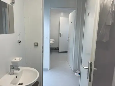 a white bathroom with a sink and a mirror at Camp Tommy in Jaklići