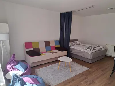 a living room with a couch and a bed at Ina in Kupres