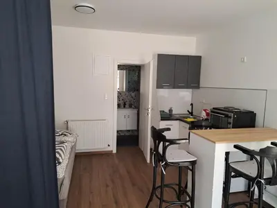 a kitchen with a counter and stools in a room at Ina in Kupres