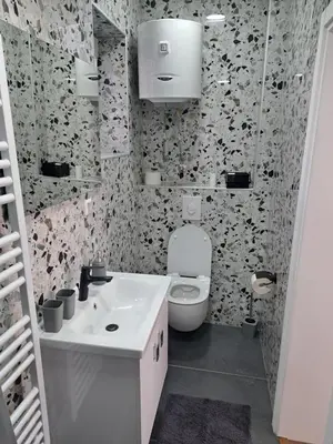 a bathroom with a white toilet and a sink at Ina in Kupres