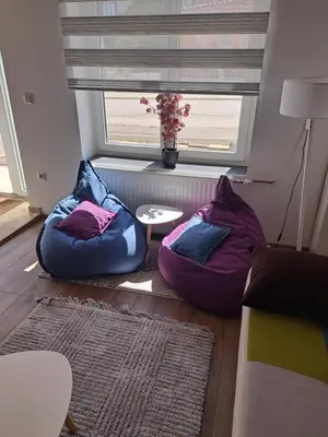 a living room with two bean bags and a window at Ina in Kupres