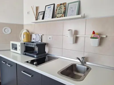 a kitchen with a sink and a microwave at Urban Studio Apartment in Tuzla