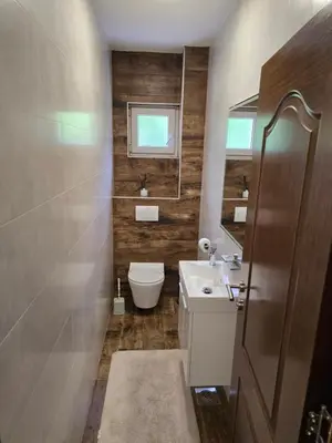 a bathroom with a toilet and a sink and a mirror at Apartmani Zlatna Kruna in Banja Luka