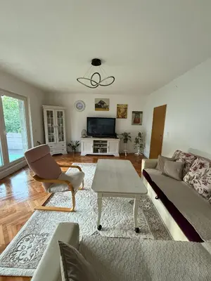 a living room with a couch and a table at Comfort house near pyramids II in Visoko