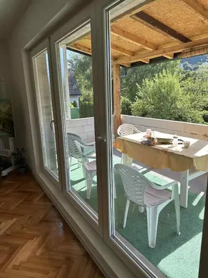 a sliding glass door with a table and chairs on a patio at Comfort house near pyramids II in Visoko