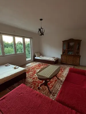 a room with a bed and a couch and a table at Comfort house near pyramids II in Visoko
