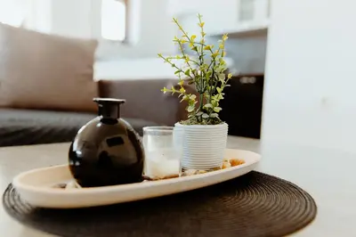 a plate with a vase and a glass on a table at Apartman Deja vu in Livno