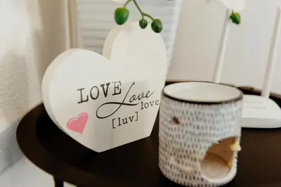 a heart vase and a candle on a table at Apartman Deja vu in Livno