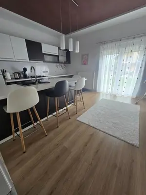 a kitchen with a table and chairs in a room at Apartman Nia in Bihać