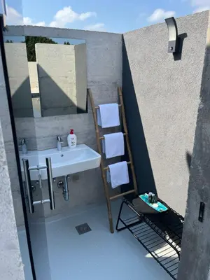 a bathroom with a sink and a ladder next to a wall at Vila Trnovac in Bužim