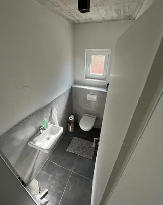 a small bathroom with a sink and a toilet at Vila Trnovac in Bužim