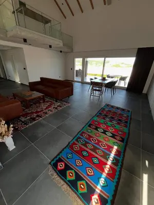 a living room with a couch and a rug on the floor at Vila Trnovac in Bužim