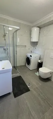 a bathroom with a shower and a toilet and a sink at Oz Lux Apartments in Bihać