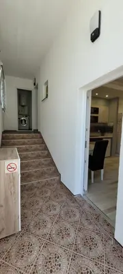an empty room with stairs and a living room at Oz Lux Apartments in Bihać