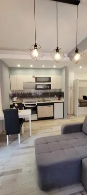 a large living room with a couch and a kitchen at Oz Lux Apartments in Bihać