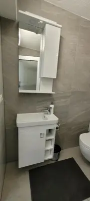 a bathroom with a white sink and a mirror at Oz Lux Apartments in Bihać