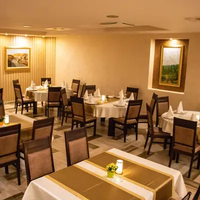 a dining room with tables and chairs in a restaurant at Motel & Restoran Sunce in Busovača