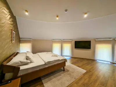 a bedroom with a bed and a flat screen tv at Motel & Restoran Sunce in Busovača