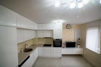 a kitchen with white cabinets and a sink at Lux Apartman Novi Grad in Bosanski Novi