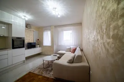 a living room with a couch and a table at Lux Apartman Novi Grad in Bosanski Novi