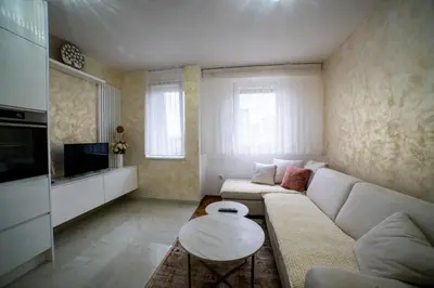 a living room with a couch and a table at Lux Apartman Novi Grad in Bosanski Novi