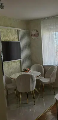 a living room with a table and chairs at Lux Apartman Novi Grad in Bosanski Novi