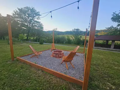 two chairs and a fire pit in a yard at Villa Rivera in Banja Luka