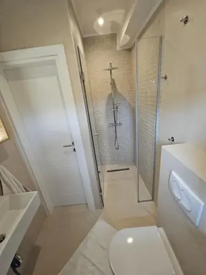 a bathroom with a shower and a toilet and a sink at Apartment DANICA in Banja Luka